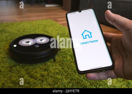 smart home app on smartphone. remote control of electronic devices in apartment. concept of controlling smart electronics in the house. Internet of Th Stock Photo
