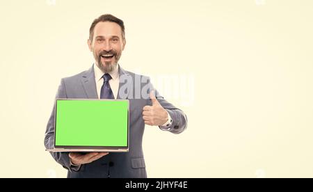 happy businessman presenting laptop for copy space copy space show thumb up, product proposal. Stock Photo