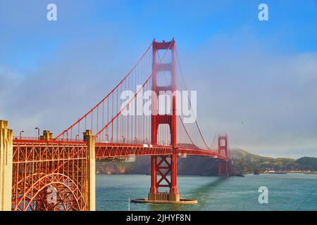 Vibrant and iconic Golden Gate Bridge on foggy morning Stock Photo