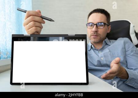 Remote education. Businessman giving a presentation on blank white board with copy space. an empty white screen on the tablet is on the table, the tea Stock Photo
