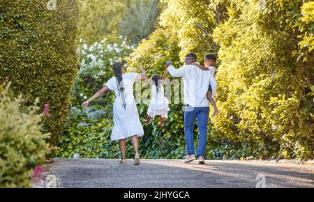 They are the people I want to walk off into the sunset with. a couple spending time outdoors with their two children. Stock Photo