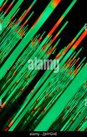 Angled abstract LED light poles in orange and green Stock Photo