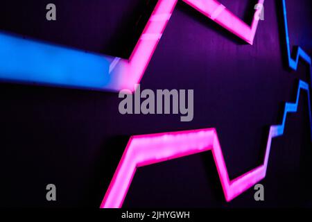Abstract neon blue and pink lights on wall pattern Stock Photo