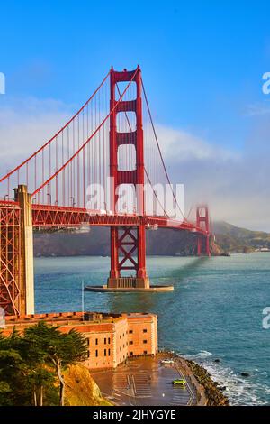 View of Golden Gate Bridge on foggy morning with Fort below Stock Photo