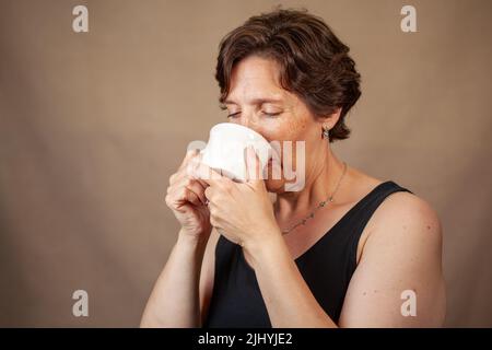 Woman enjoying a nice cup of coffee Stock Photo