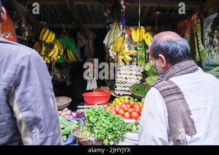 Darjeeling, West Bengal, India. June 22, 2022. A village man sitting on the road side of a busy area in Bagdogra for sell his vegetables. Stock Photo
