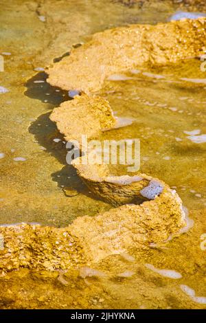 Up close to terrace shelf filled with water in Yellowstone hot spring Stock Photo