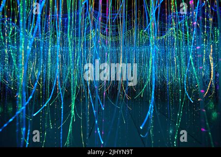 Mirror hallway filled with glowing strings Stock Photo