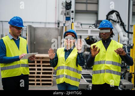 Group of robotics workers using virtual reality in their work Stock Photo