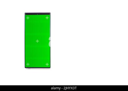 Phone mobile telephone with a vertical green screen in tram chroma key smartphone technology cell phone on white background isolate. Stock Photo