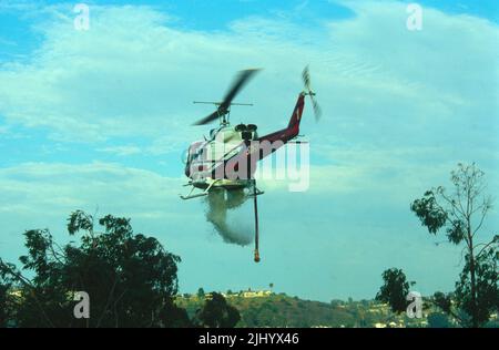 San Diego Fire-Rescue Copter 1 doing a water drop on a brush fire in San Diego, California Stock Photo