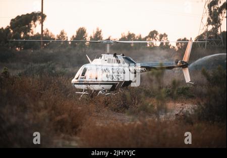 SDPD ABLE helicopter lands to assist fire fighters during a brush fire Stock Photo