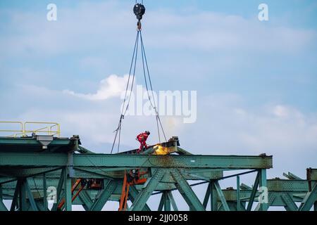 A construction welder at work on the decommissioned Champlain Bridge in Montreal, Canada. Stock Photo