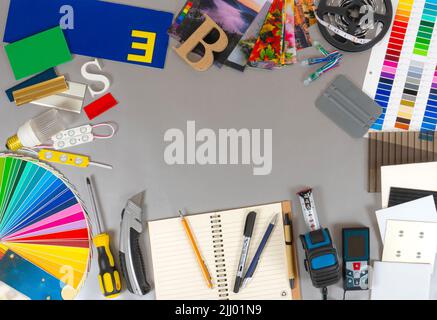 Outdoor advertising agency tools, accessories and material samples. Palette of film colours, print samples on fabric, plastic samples and instruments. Stock Photo