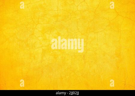 Abstract rustic yellow and orange cracked wall background texture design. Stock Photo