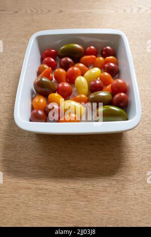 Food stuff. Fresh harvested colorful tomatoes. Group of healthy multi colored and organic cherry tomato vegetables or delicious fruit, perfect for raw Stock Photo