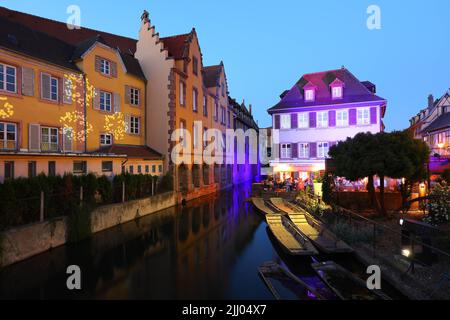 Colmar, Alsace, France April 2022 : Traditional half-timbered houses and restaurants on street in Colmar at twilight , Alsace rigion, France Stock Photo