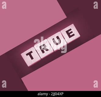 concept word true on wooden cubes on black background Stock Photo