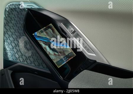 A touch panel that allows you to control all the car's functions is located on the rear door of the new, luxurious BMW 7 Series. Poland, Katowice, 14. Stock Photo