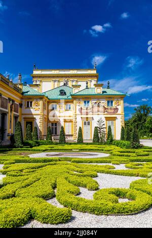 Garden topiary and ornate yellow exterior of Italian style 17th century baroque royal Wilanow Palace, Warsaw, Poland Stock Photo