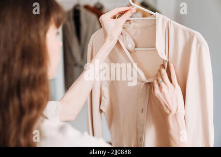 White young woman in apron doing housework at home Stock Photo