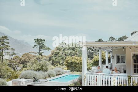The dinner hour is a sacred. a family having lunch on the porch at home. Stock Photo