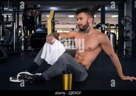 Beautiful male torso. Men tattoo casual fashion. muscular bodybuilder  posing. sexy portrait of sport man. Tattooed muscular guy posing in studio.  Workout for good health. Prank to abdominal muscles Stock Photo by ©