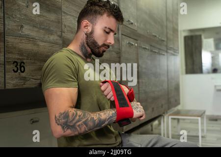 Handsome male with tattoos in his 20s getting ready for training Stock Photo