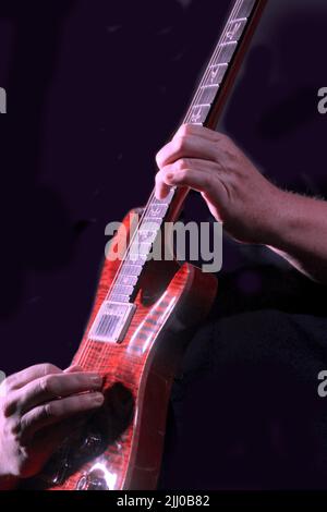 A musician plays an electric guitar. Stock Photo