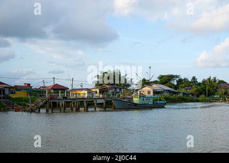 Terengganu, Malaysia: Jan 16, 2022 - Single fishing boats moored on the bank of the river in the Malaysian East Coast Stock Photo