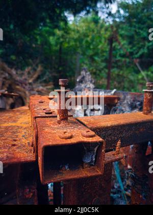 Close up of a rusted and burnt screw on a massage chair Stock Photo