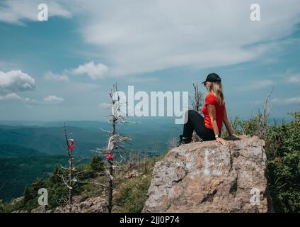 A girl on top of Falaza mountain looks at a beautiful mountain valley. Travel and tourism. Hiking High quality photo Stock Photo