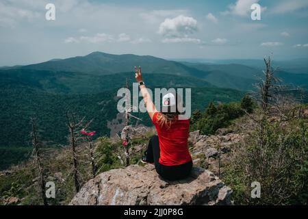 A girl on top of Falaza mountain looks at a beautiful mountain valley. Travel and tourism. Hiking High quality photo Stock Photo