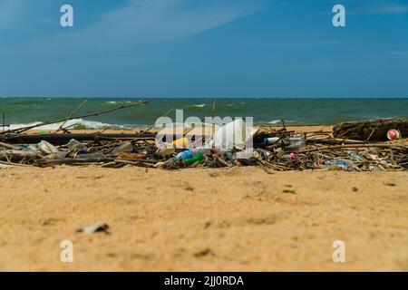 Plastic and wood waste on the beach pollute the environment. Negombo, Sri Lanka. Stock Photo