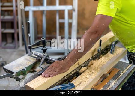 master carpenter polishing some wooden slats Stock Photo