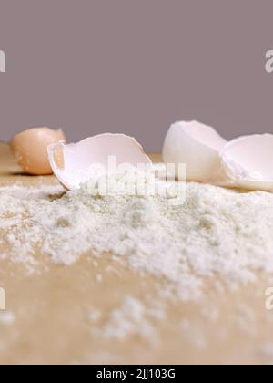 Halved egg shells with flour laying on baking paper Stock Photo