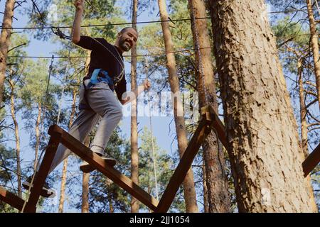 Man steps on the rope hanging in the air Stock Photo