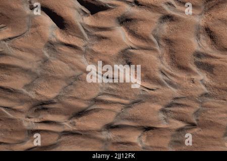 what remains of the water running on the sand. Stock Photo