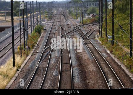 Train tracks on the East Coast Main Line. The hot weather has led to trains operating at reduced speeds on some lines, and the East Coast Mainline seen here near Peterborough, Cambridgeshire, is not running trains to London tomorrow. Stock Photo