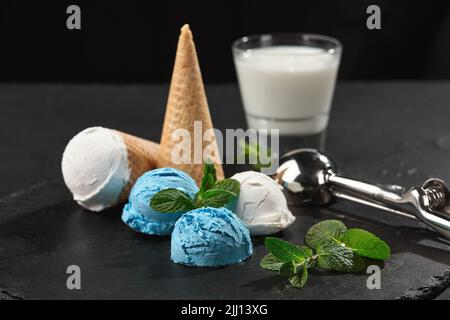 Close-up shot of a creamy and blueberry ice cream served on a dark slate, black background. Stock Photo