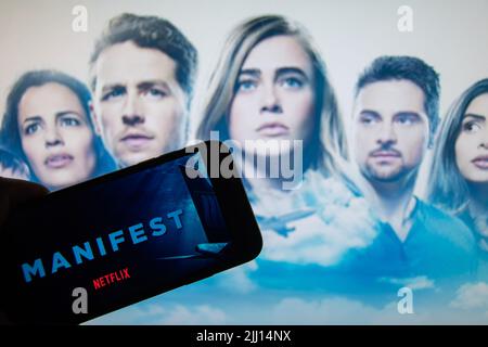 Rheinbach, Germany  22 July 2022,   The logo of the new Netflix series "Manifest" on the display of a smartphone in front of the TV Stock Photo