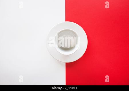 Empty tea cup isolated on red and white background Stock Photo