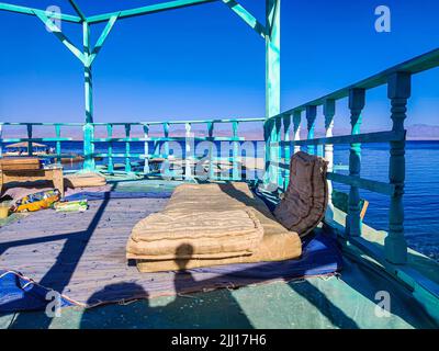 Cottage in a Bedouin Camp on the Sea in Ras Shitan in Oasis in Sinai, Taba desert with the Background of the Sea and Mountains. Stock Photo