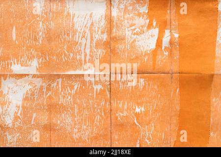 Old orange paper folded and stained, texture background Stock Photo