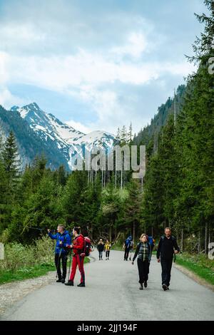 Tourists on the trail in the mountains Stock Photo