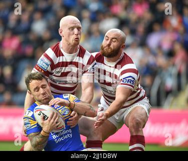 Leeds, England - 21st July 2022 -  Richie Myler (16) of Leeds Rhinos tackled by Liam Farrell and Jake Bibby of Wigan Warriors. Rugby League Betfred Super League Leeds Rhinos vs Wigan Warriors at Headingley Stadium, Leeds, UK Stock Photo