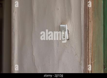Selective focus shot of light switch used in old style country house on the wall. Stock Photo
