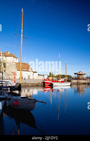 Honfleur, France-October 13,2021: The yachts in port.Honfleur itself has a small new harbour on the small Riviere La Morelle leading to the Bassin Car Stock Photo