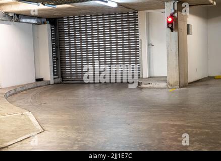 apartment building sliding garage door with stop lights , one way Stock Photo