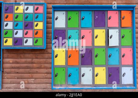 colourful storage lockers on a wall, colours of the rainbow Stock Photo
